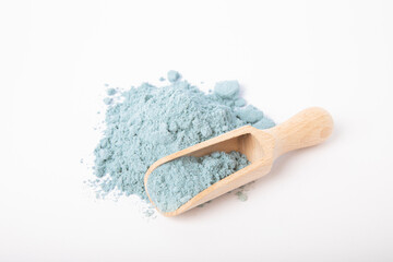 Fototapeta na wymiar Blue spirulina powder in wooden spoon isolated on white background. Natural vegan superfood. Food supplement. Phycocyanin extract.