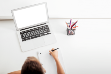 school at home through online homeschooling. the child is sitting at the computer