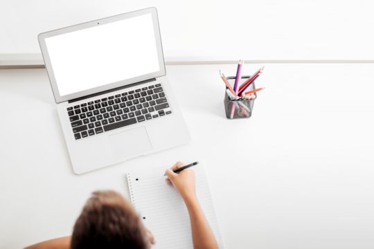 school at home through online homeschooling. the child is sitting at the computer