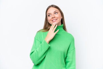 Young beautiful blonde woman isolated on white background looking up while smiling