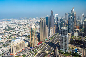 Fototapeta na wymiar wide avenue among the skyscrapers of Dubai top view.