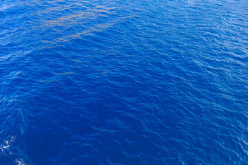 Very nice sea water background or backdrop with selective focus. Small waves of natural water surface texture.