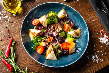 Warm chicken liver salad with port wine-honey sauce. Carrot cream, bacon, cherry tomatoes, brioche. Delicious healthy traditional food closeup served for lunch in modern gourmet cuisine restaurant