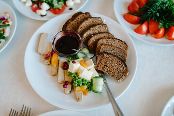 Serves dinner on a festive table. Food, Salads, Meat, Fish Meals. Festive table at wedding banquet. Decor. Details. Top view.