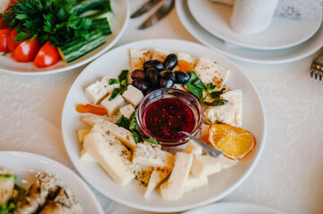 The holiday table with appetizer cheese, meat snacks. Served table with food. Festive table. Wedding table, food.