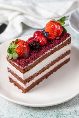 Fruit and whipped cream cake. Layered cake with forest fruit and cream on the plate. close up