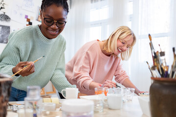 Young female artists are in their painting studio
