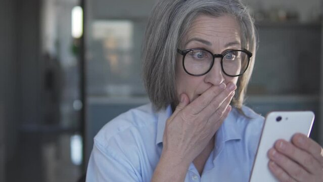 Ault lady reading shocking news in internet, receiving letters with spam content