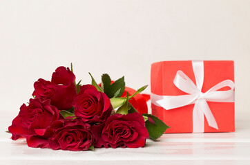 Valentines day gift box with red roses on white table