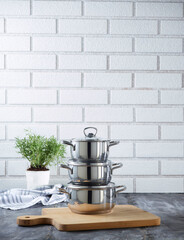 pans in front of brick wall