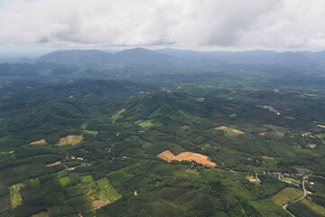 Aerial view from the top view of the forest, mountain, meadow and abundant plantation fields on summer