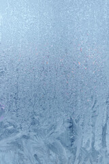 Frozen window, frost drawing on glass in cold winter