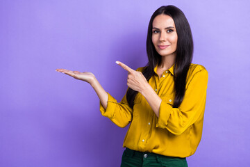 Portrait of pretty lady indicate finger empty space hand demonstrate news isolated on purple color background