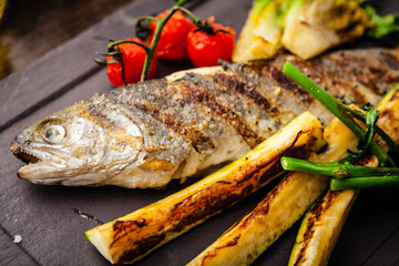 Rainbow trout grilled. Vegetables, white wine sauce. Delicious healthy traditional food closeup served for lunch in modern gourmet cuisine restaurant - 563041432