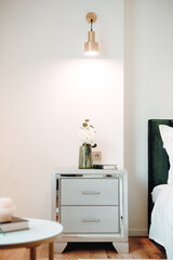 Close up of beautiful nightstand in elegant and comfortable modern bedroom. Interior design details