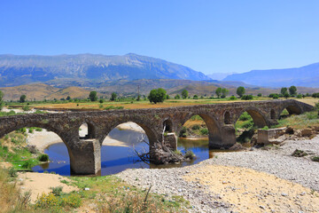 Fototapeta na wymiar Landscape with ancient stone bridge in Albania