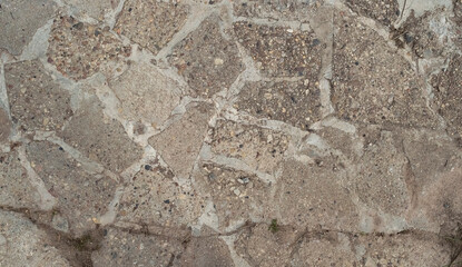 Close-up top view of a cobblestone road. Road texture