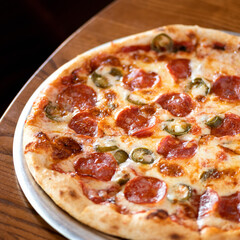 Fragment of traditional Italian pizza with minced meat, cheese and basil. Italian food. Top view . Close-up. Soft focus