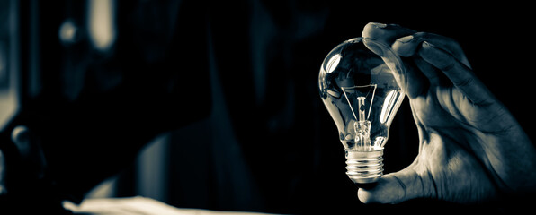Close up hand choose light bulb or lamp for human resources or leadership and creativity thinking idea motivation or vision and knowledge learning. © Jintana