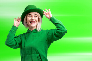 Beautiful smiling woman wearing green hat. St. Patrick's Day celebration. Bright green background.