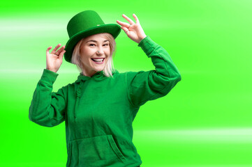 Beautiful smiling woman wearing green hat. St. Patrick's Day celebration. Bright green background.