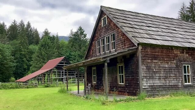 The historic wooden house and barn on the abandoned Kestner Homestead in the Olympic National Park. The homestead is now visited on a hiking trail - Nr Quinault, Washington, USA