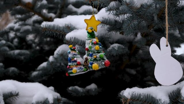 Toys on the Christmas tree outside in winter.