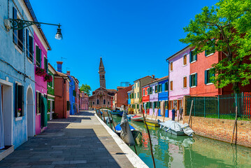 Fototapeta na wymiar Street with colorful buildings in Burano island, Venice, Italy. Architecture and landmarks of Venice, Venice postcard
