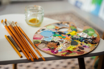 art palette with paint and brushes