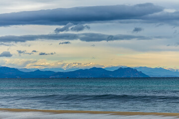 View of the the bay of St. Tropez, with snow covered Alpes Maritimes, France