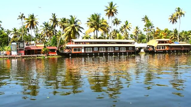 Showing beautiful backwater and houseboat of alleppey or Alappuzha from House boat. Boat moving through the waves to the destination. 