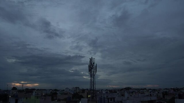 Time Lapse of clouds over dense population ctiy area in raipur, chhattisgarh, Time Lapse of dark clouds in rain or rainy season, Dense clouds over city covers sun at evening mobile tower in city area