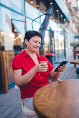 Smiling mature woman drinking coffee