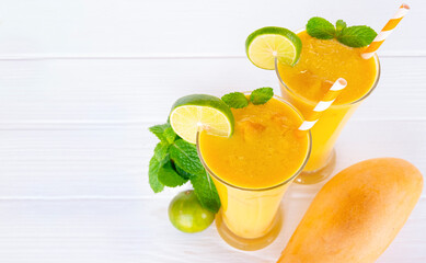 Mango smoothies yellow colorful fruit juice milkshake blend beverage healthy high protein the taste yummy In glass,drink to lose weight drink episode morning on white gray background.