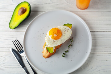 Avocado toast with melted cheese and scrambled eggs