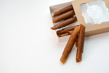 Fruit paste. Berry candies in packing boxes. apple, pear, orange, plum, marshmallow rolls	