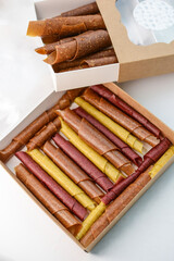 Fruit paste. Berry candies in packing boxes. apple, pear, orange, plum, marshmallow rolls	
