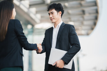 Businessmen making handshake in the city business etiquette, congratulation, merger and acquisition concepts.