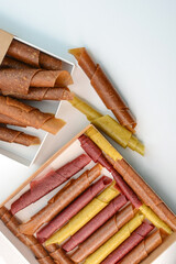 Fruit paste. Berry candies in packing boxes. apple, pear, orange, plum, marshmallow rolls