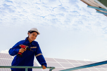 Female engineer technician professional working solar cell station organic farm standing on...