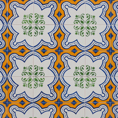 Fragment of building wall with colorful ceramic wall tiles, Azulejo close up. Abstract decorative background, textured ornate pattern for design or backdrop. Traditional ornate Portuguese architecture