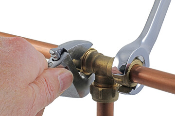 A pair of wrenches being used to adjust a compression tee fitting transparent png