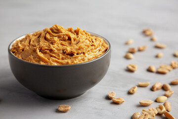 Yummy Organic Peanut Butter in a Bowl, low angle view. Close-up.