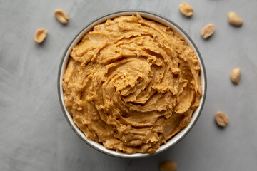 Yummy Organic Peanut Butter in a Bowl, top view. Flat lay, overhead, from above.