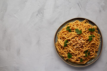 Homemade Asian Peanut Sauce Noodles on a Plate, top view. Flat lay, overhead, from above. Space for text.