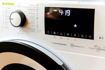 Display washing dryer machine. Macro photo part of modern home washing dryer machine dial.