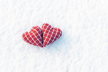 A two red heart flat lay on the snow top view, valentines day concept.White snow background.Copy space.