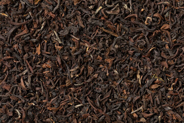 Indian Tukvar darjeeling dried tea leaves close up full frame as background