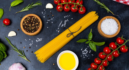 Food background from pasta, spices, herb on black table