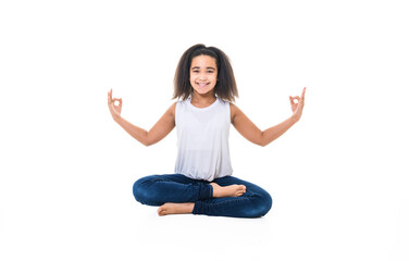 Adorable 9 years child girl on studio white background doing yoga